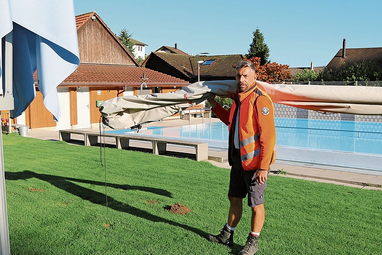 Hausdienstleiter Danny Simmank bringt die Sonnenschirme vom Meierbädli ins Winterlager.Bild: Melanie Bär